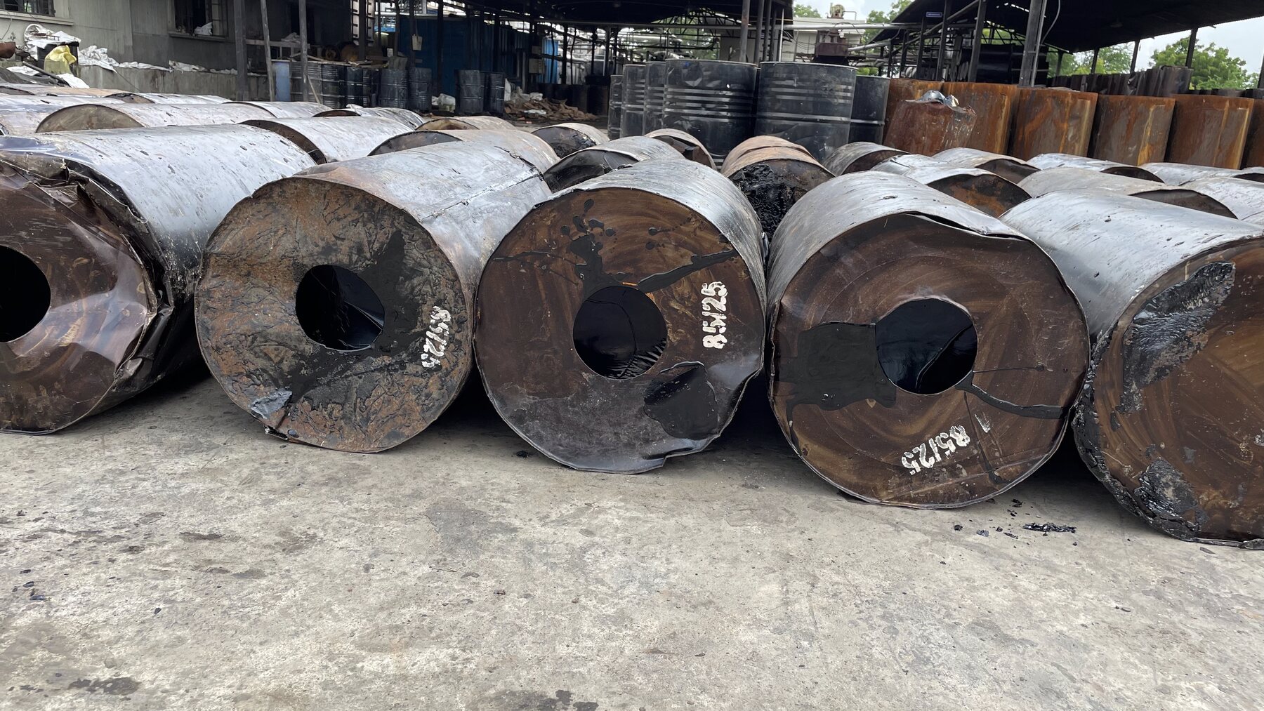 Industrial drums stored in a yard