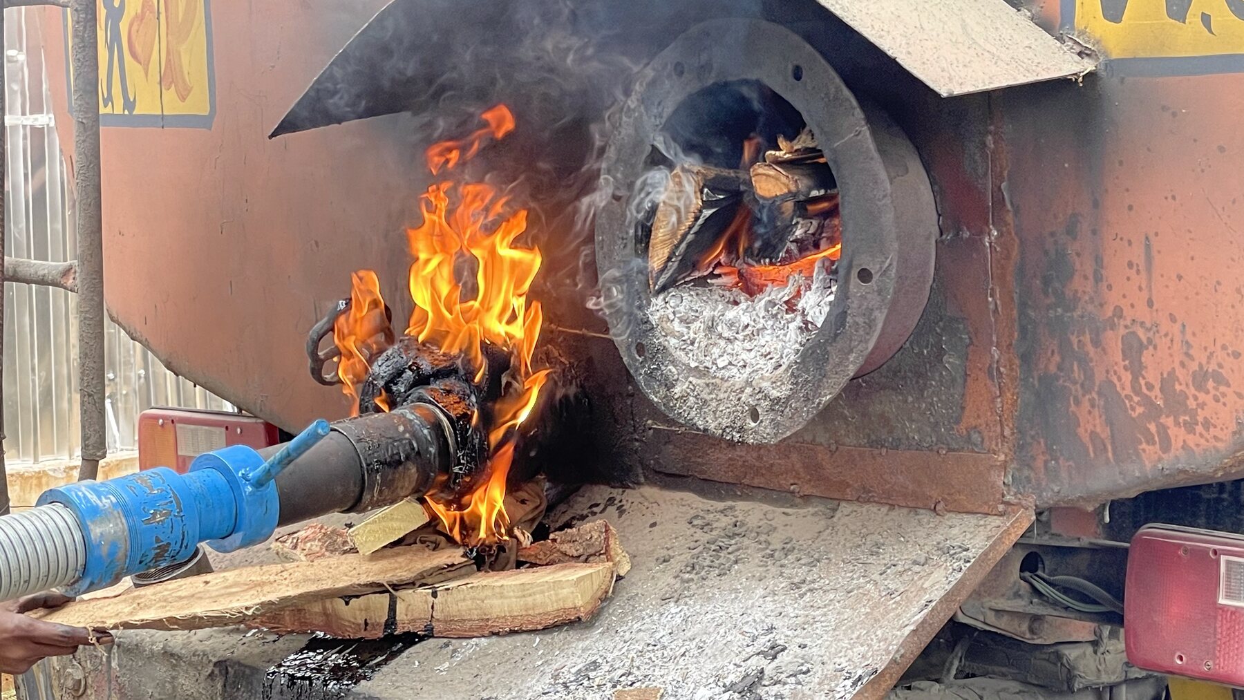 Bituminous material being heated inside industrial equipment